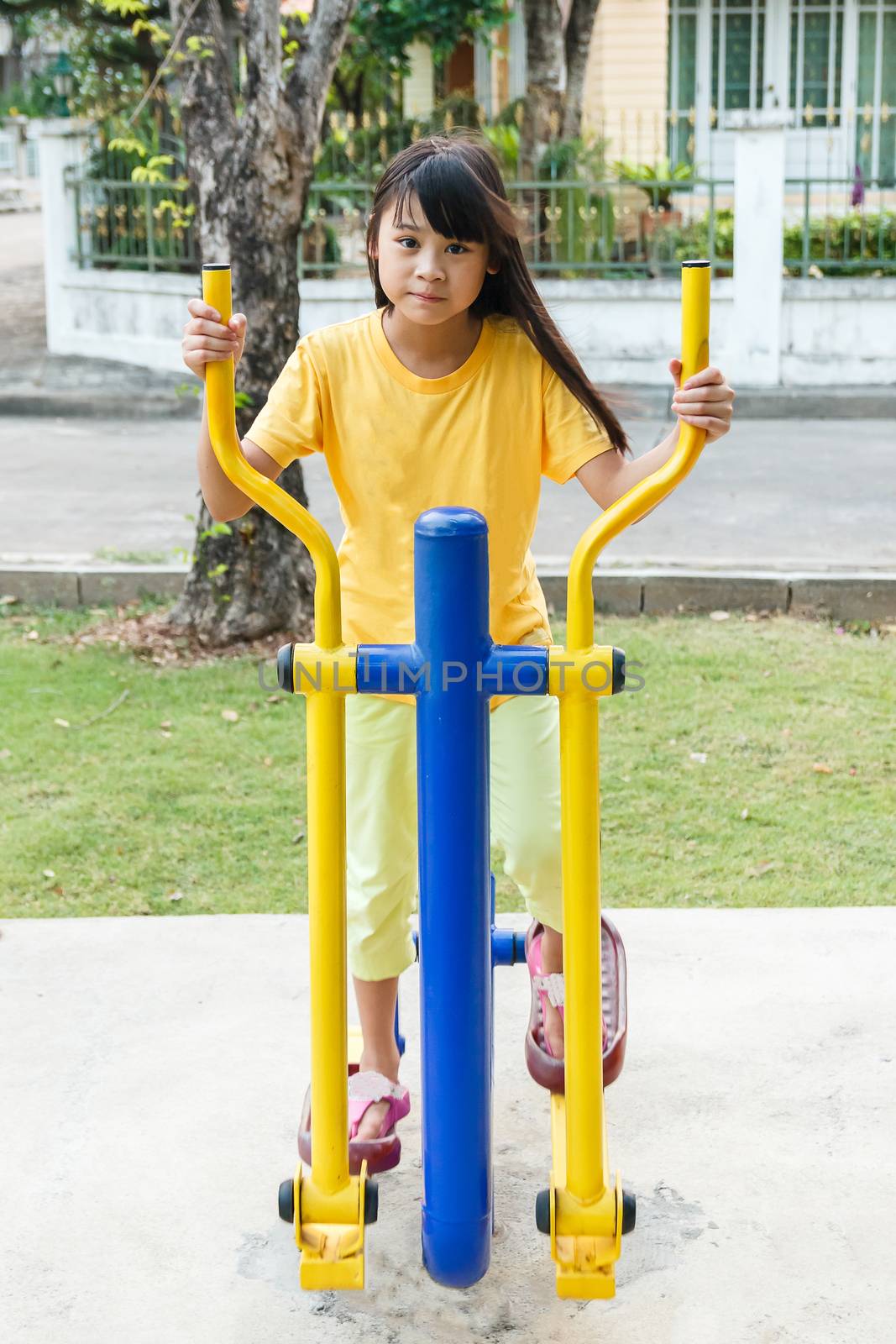 Thai girl working out with Elliptical.