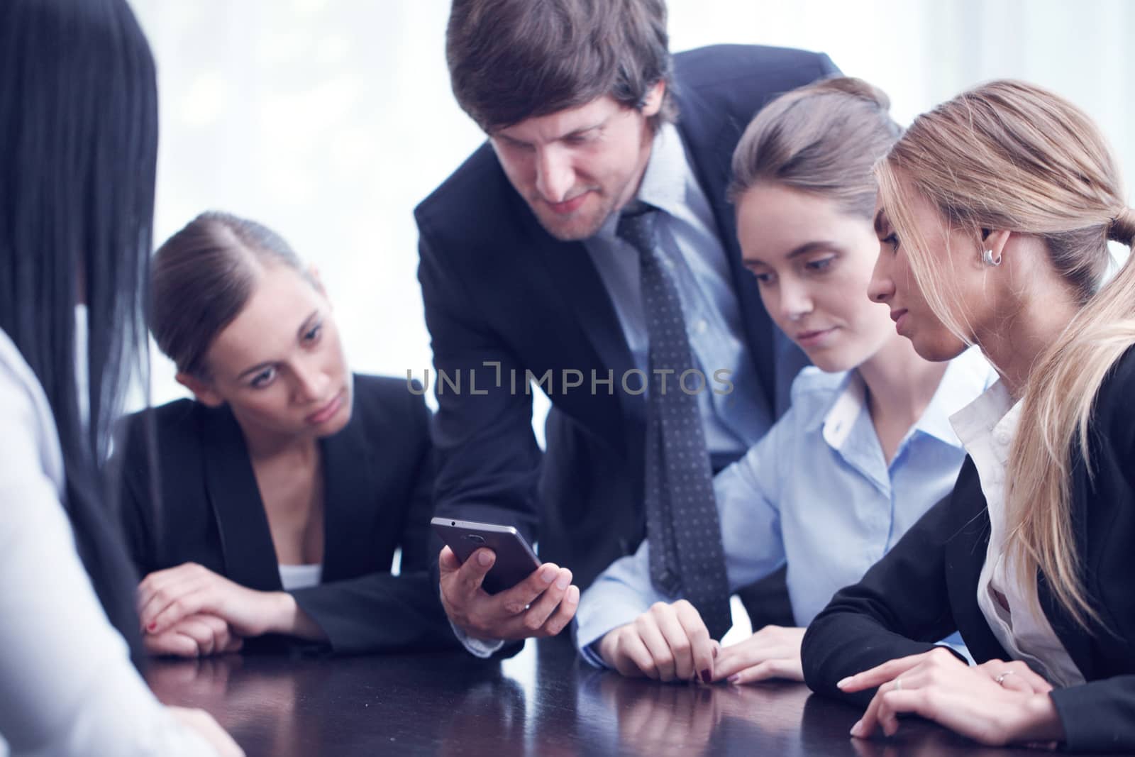 Business people using smartphone by ALotOfPeople