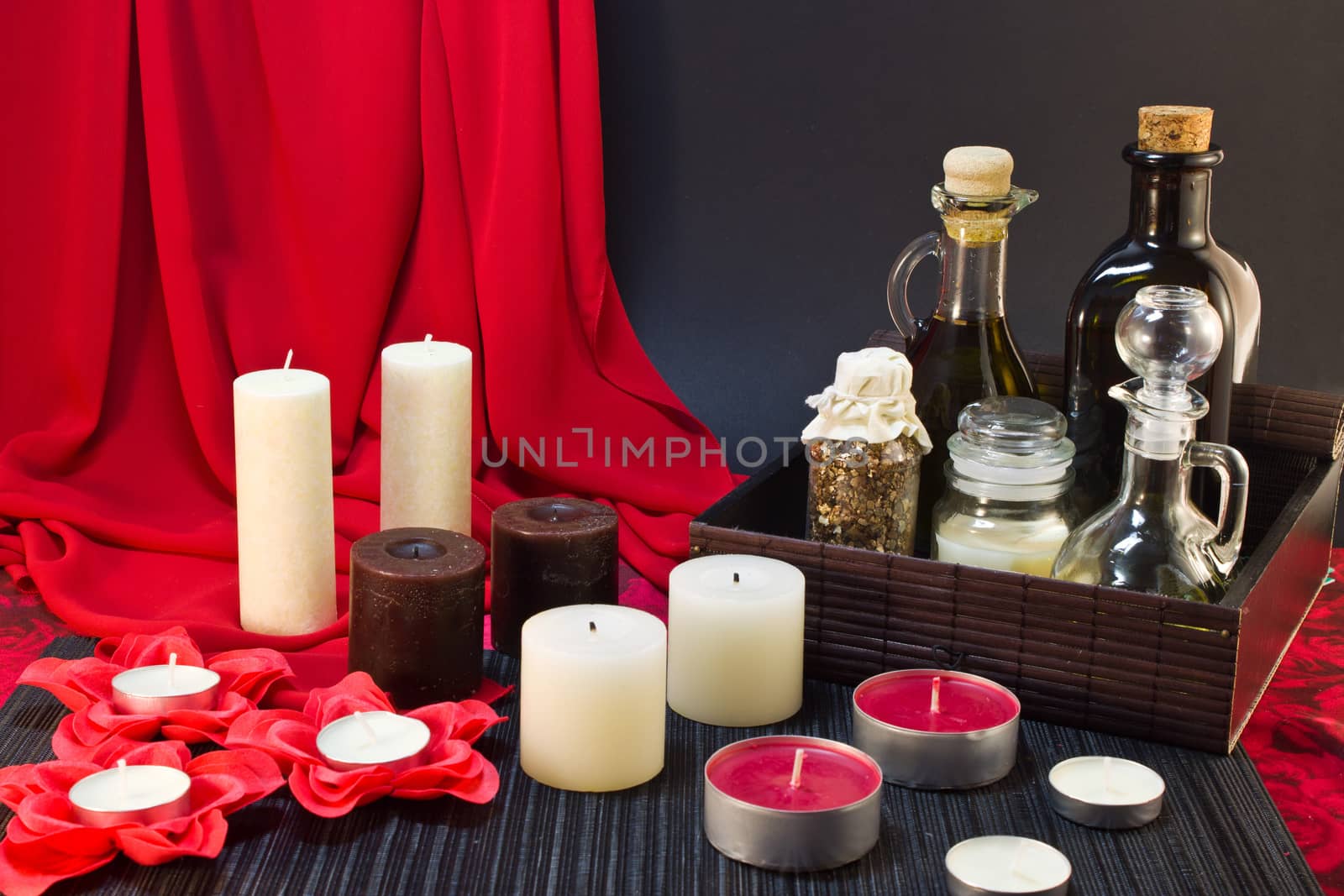 Still life of candle, tools for massage creams for skin care and bath salt.