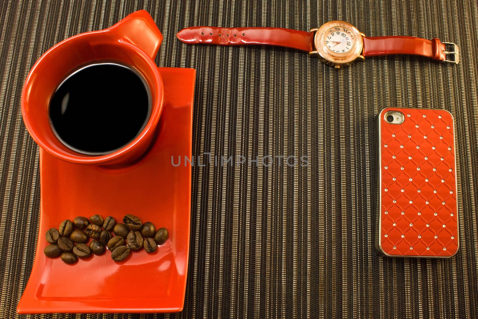 Red cup of coffee, watches with red strap, phone in red bumper