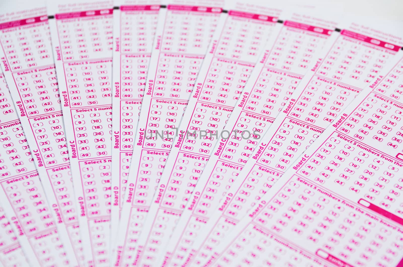 Blank lotto tickets scattered on white background

