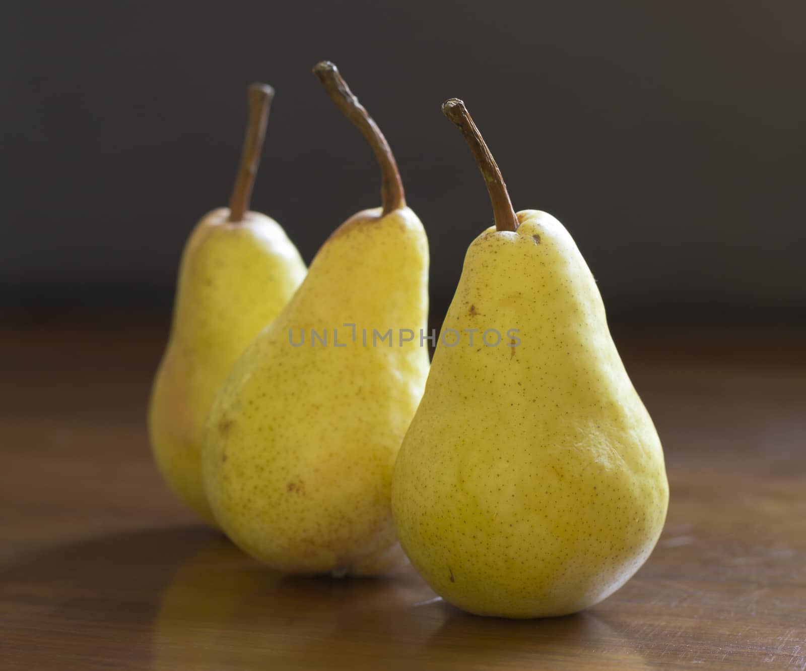 Fresh pears on wooden table by Kidza