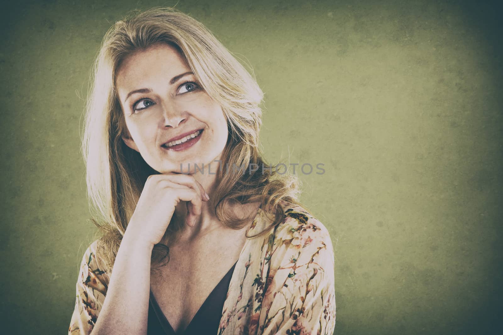 blond woman wearing green scarf on vintage background