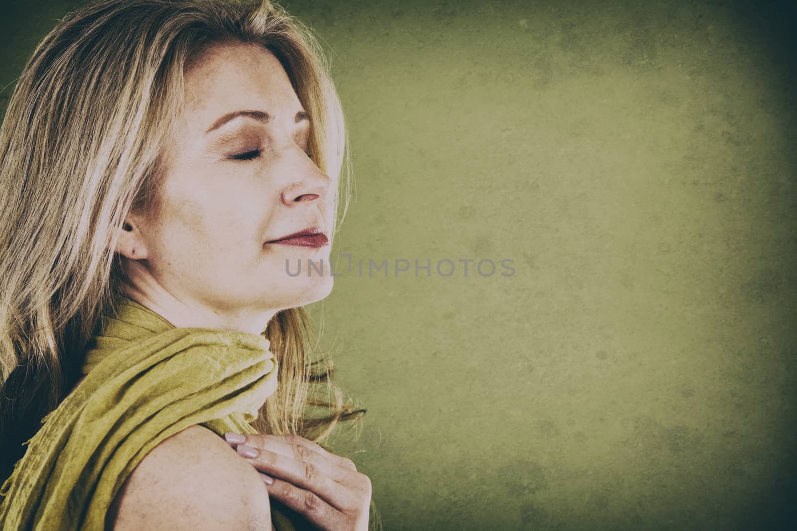 blond woman wearing green scarf on vintage background