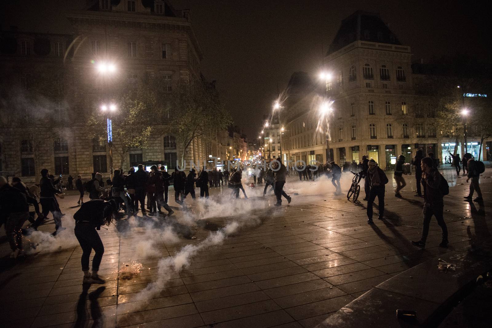 FRANCE, Paris: Nuit Debout protesters stand among smoke on the Place de la République in Paris during violent protests following the Nuit Debout (Up All Night) movement rally, on April 23, 2016. The Nuit Debout or Up All Night protests began in opposition to the Socialist government's labour reforms seen as threatening workers' rights, but have since gathered a number of causes, from migrants' rights to anti-globalisation.