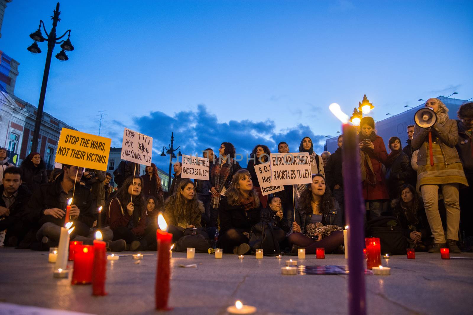 SPAIN, Madrid: Protesters gather with candlelights during a rally at Sol Square in Madrid, Spain on April 22, 2015 to protest against EU-Turkey agreement and to show support to refugees for a 24 hours vigil.