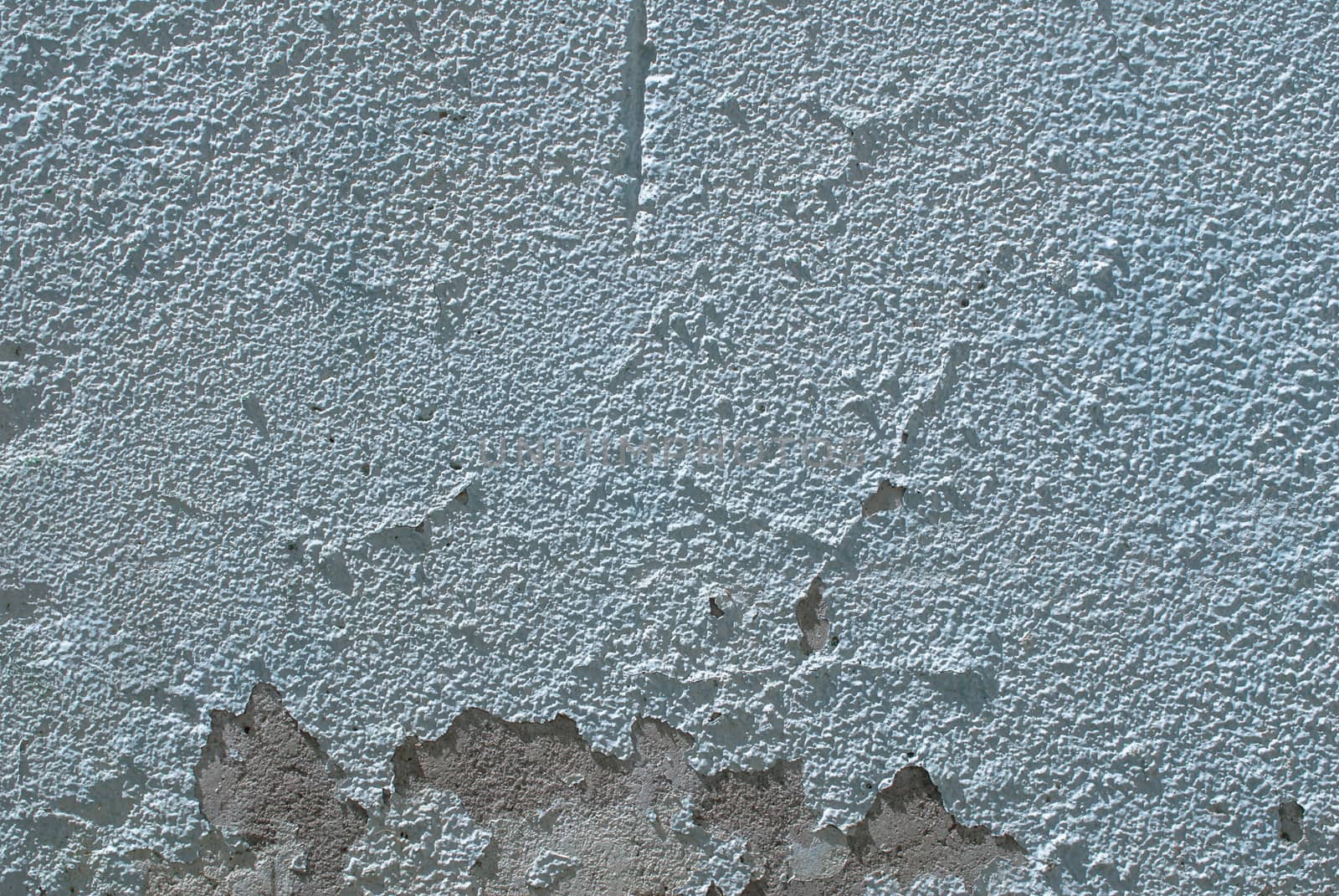 fragment of a concrete wall, which has undergone deformation due to prolonged exposure to various climatic conditions