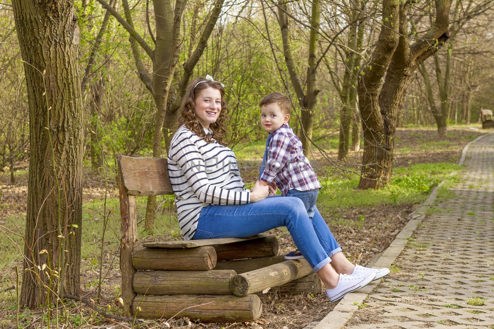 beautiful pregnant woman outdoor with her little boy by manaemedia