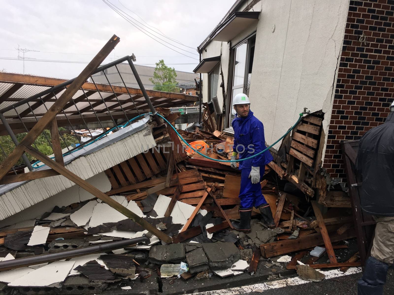 JAPAN, Mashiki: A man is pictured in front of the rubble of a collapsed house following an earthquake, on April 23, 2016 in Mashiki near Kumamoto, Japan. As of April 20, 48 people were confirmed dead after strong earthquakes rocked Kyushu Island of Japan. Nearly 11,000 people are reportedly evacuated after the tremors Thursday night at magnitude 6.5 and early Saturday morning at 7.3.