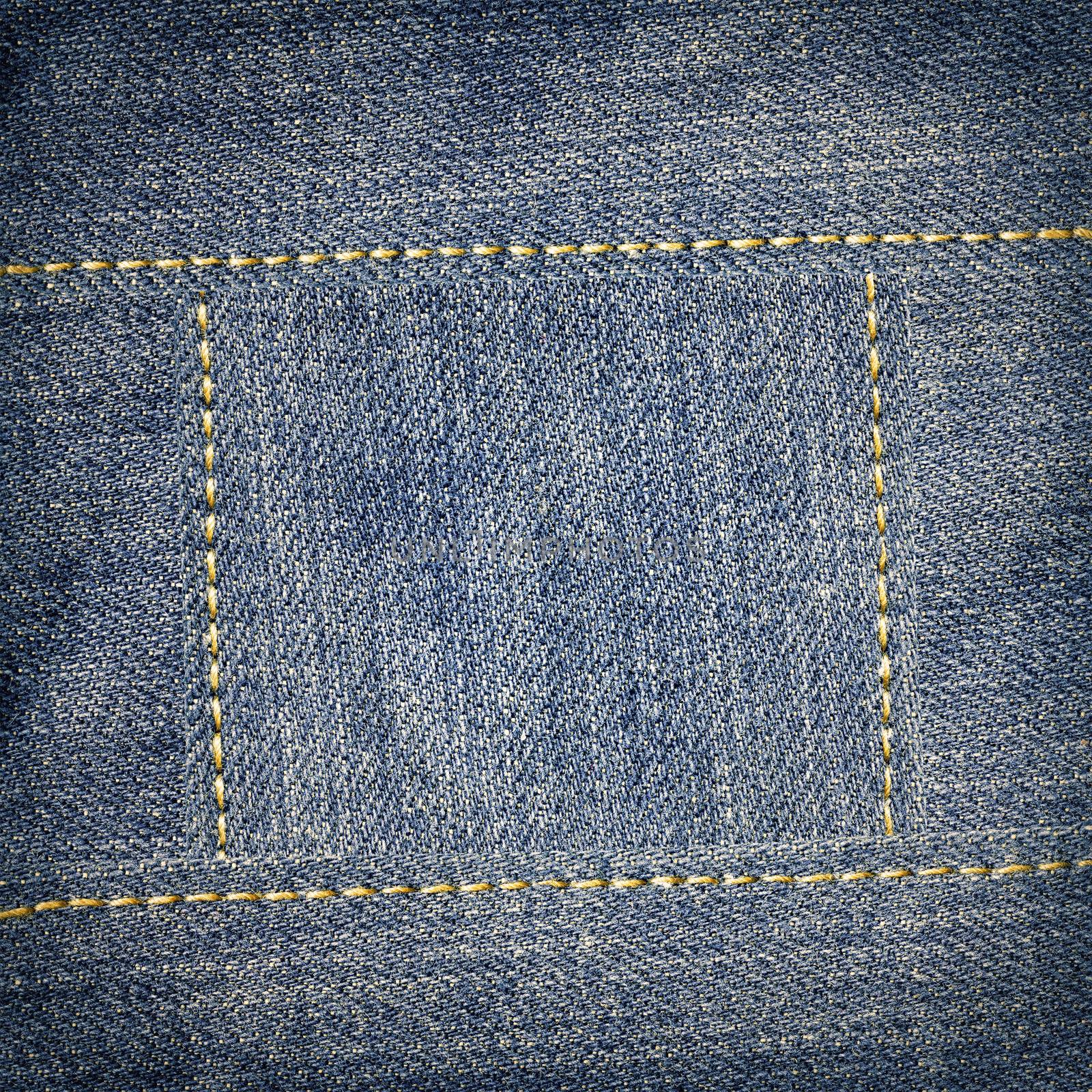 Jeans texture with yellow seams frame background