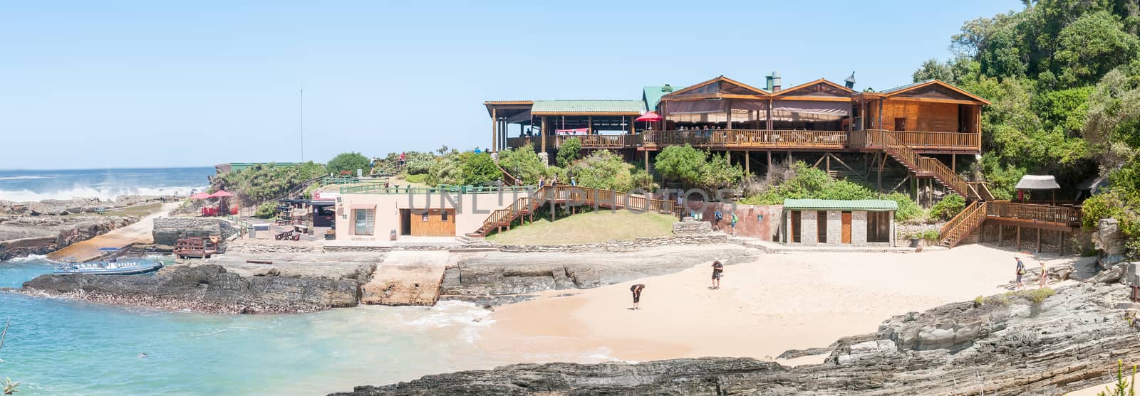 STORMS RIVER MOUTH, SOUTH AFRICA - FEBRUARY 29, 2016:  Unidentified tourists at the restaurant, a beach and a small harbor at Storms River Mouth