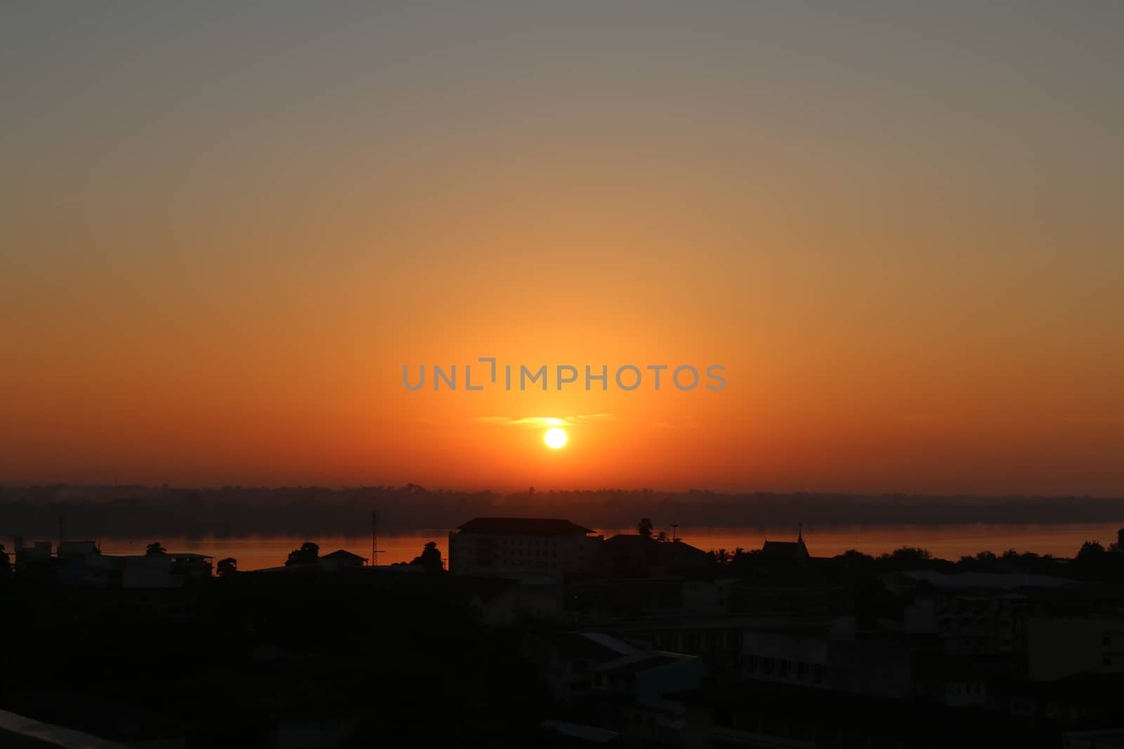 Sunrise over Mekong River in a Mukdahan city skyline