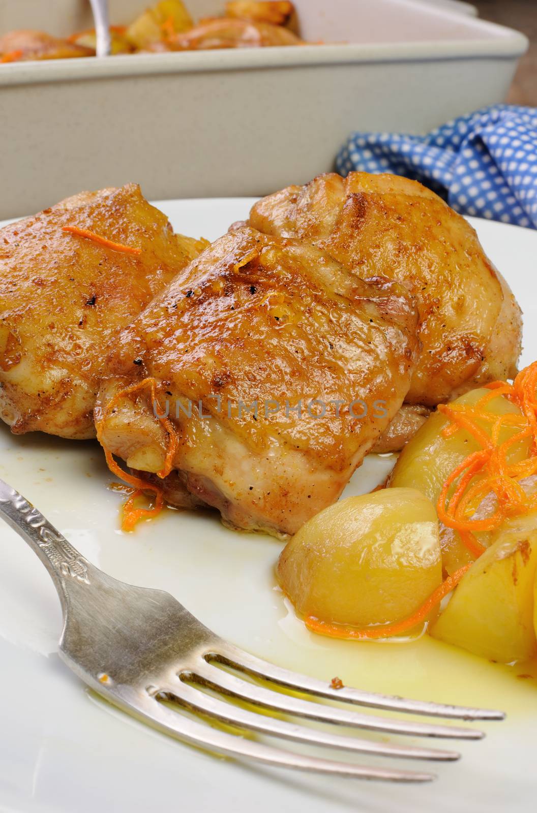  Fried chicken haunch  with boiled potatoes and carrots on a plate