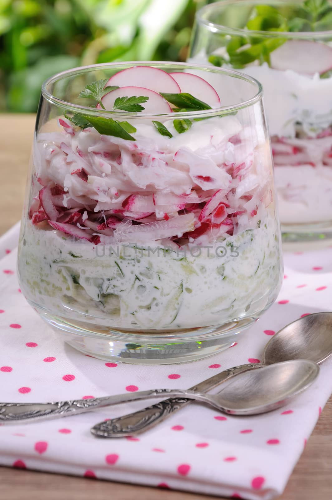 Salad of grated radish and cucumber with yogurt in a glass