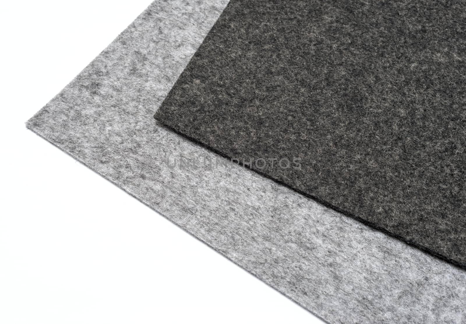 gray felt pieces on a white background
