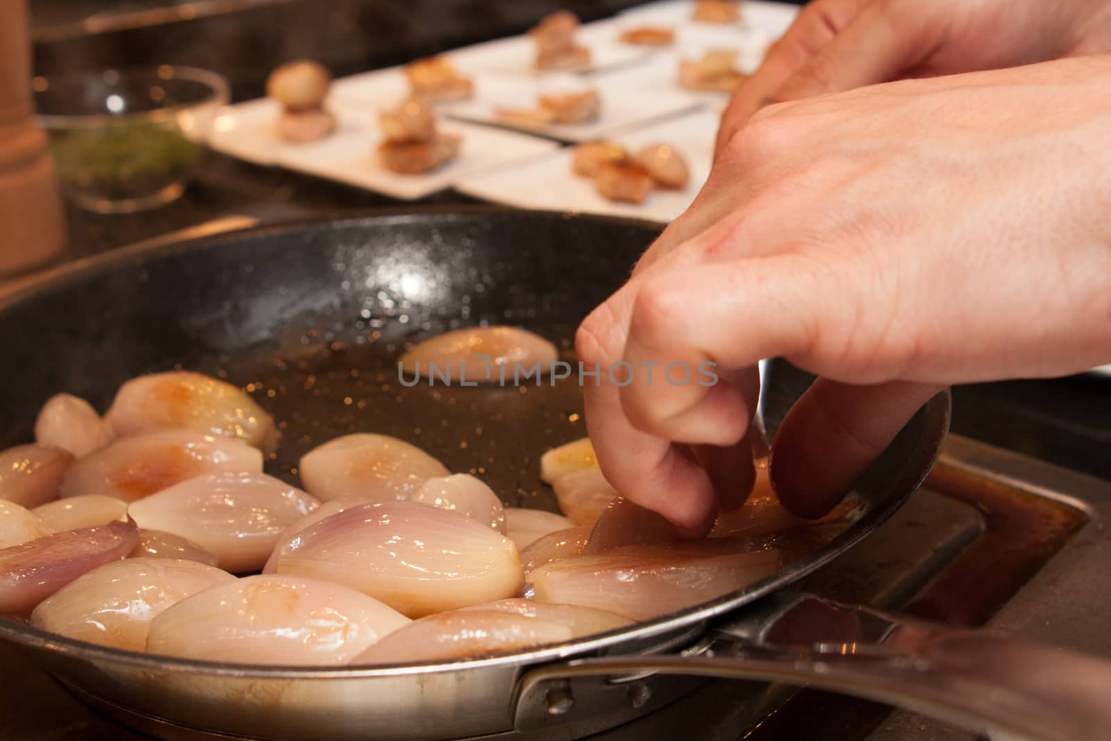 cook put shallot onion on pan