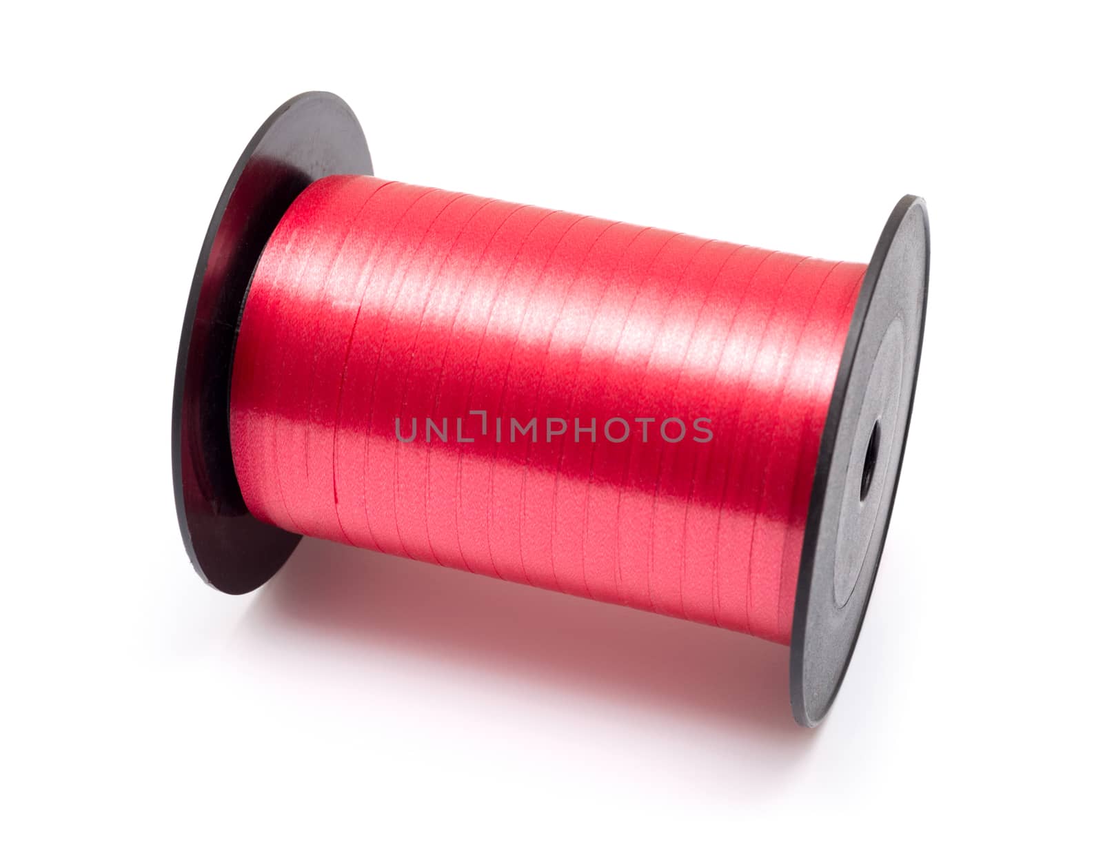 Reel of pink ribbon isolated on white background