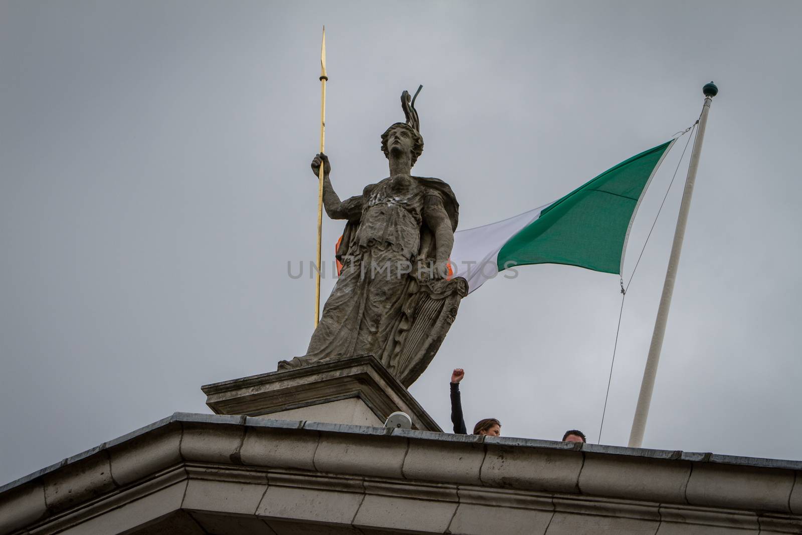 IRELAND, Dublin: A picture is taken of the Hibernia statue on the  General Post Office facade as thousands demonstrate to commemorate the 100 year anniversary of the 1916 Easter Rising in front of the GPO General Post Office in central Dublin on April 24, 2016. Irish people has the opportunity to host a proper ceremony on behalf of all citizens that will pay proper tribute to the men and women of 1916 and to the Proclamation of the Irish Republic Thousand of people celebrate the big day in Ireland.