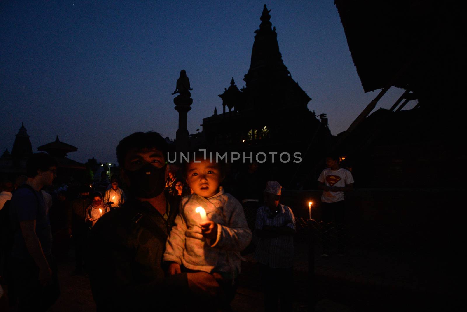 NEPAL, Patan: Nepalese residents gather to light candles during a vigil to mark the first anniversary of a devastating earthquake in Durbar Square in Patan, Kathmandu valley on April 24, 2016. Nepal on April 24 held services remembering thousands of people killed in a devastating earthquake one year ago, as authorities vow to expedite long-delayed reconstruction projects. Some 9,000 people were killed in the 7.8-magnitude quake that struck April 25, 2015 and its aftershocks.