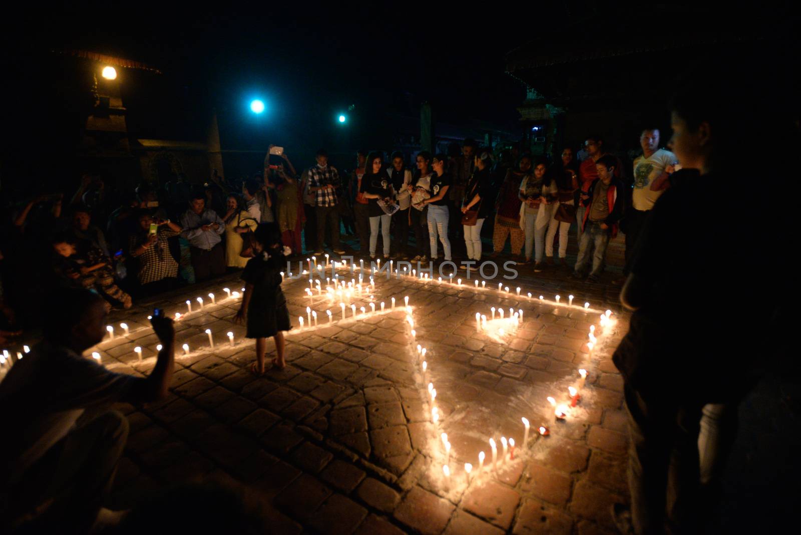 NEPAL, Patan: Nepalese residents gather to light candles during a vigil to mark the first anniversary of a devastating earthquake in Durbar Square in Patan, Kathmandu valley on April 24, 2016. Nepal on April 24 held services remembering thousands of people killed in a devastating earthquake one year ago, as authorities vow to expedite long-delayed reconstruction projects. Some 9,000 people were killed in the 7.8-magnitude quake that struck April 25, 2015 and its aftershocks.