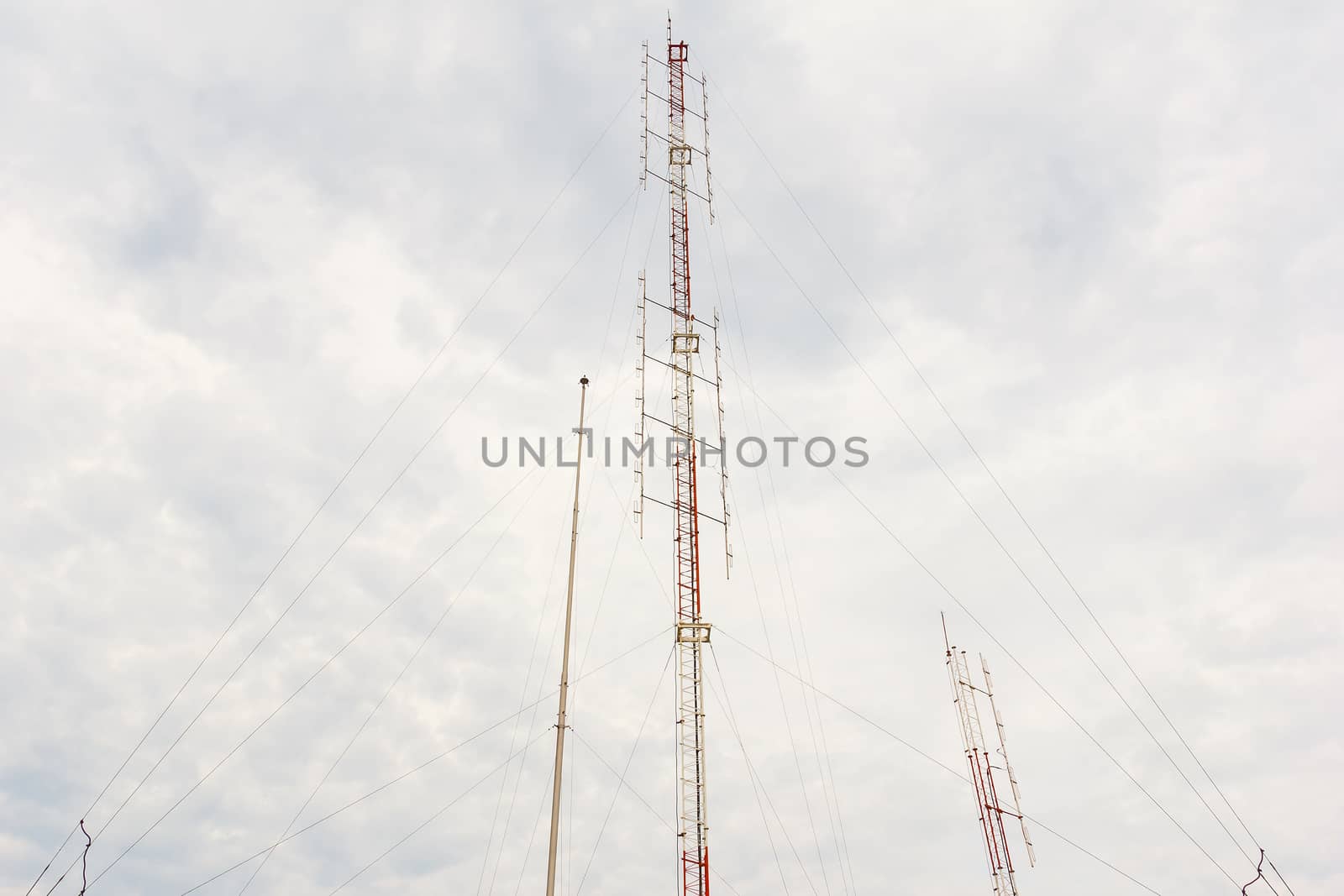 Radio tower with cloudy sky in background.