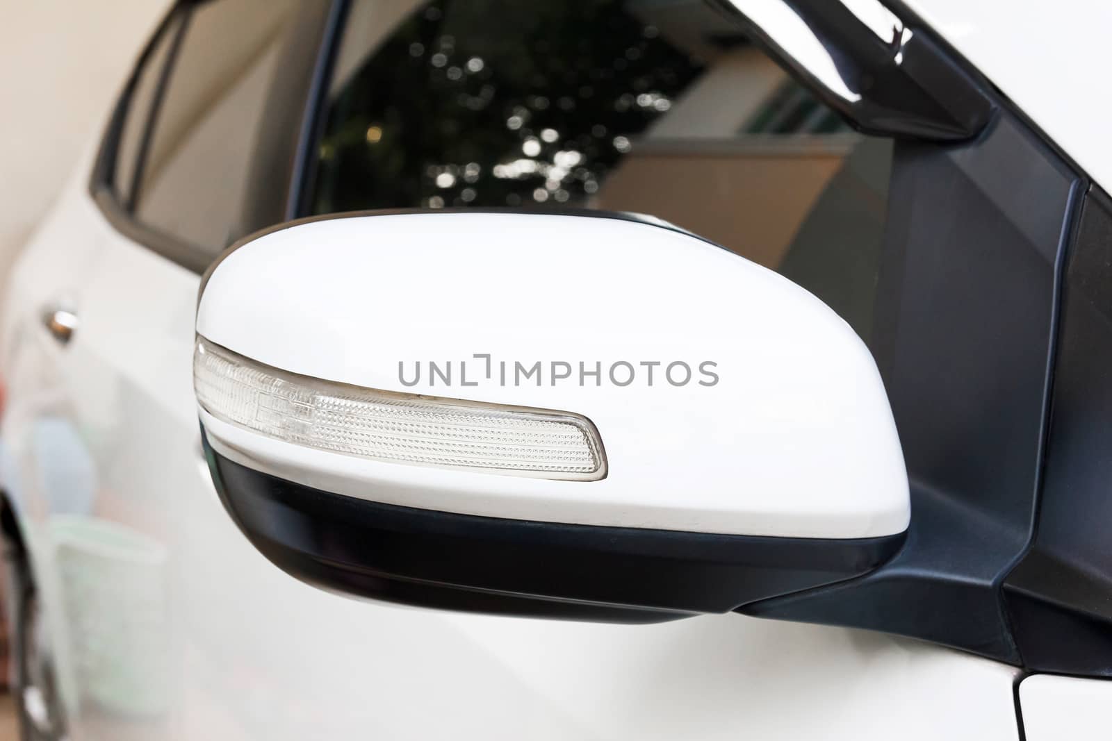 Back view of white car side mirror.