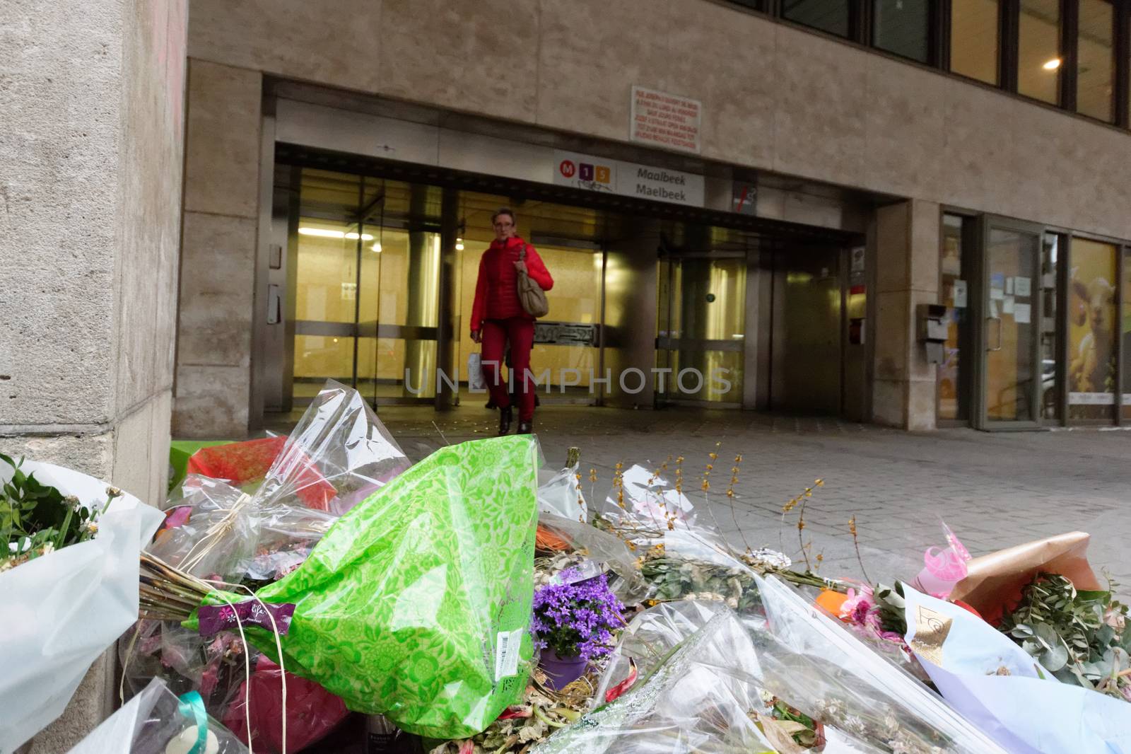 BELGIUM, Brussels : A passager walks in front of Maelbeek - Maalbeek metro station on its re-opening day on April 25, 2016 in Brussels, after being closed since the 22 March attacks in the Belgian capital.Maelbeek - Maalbeek metro station was hit by one of the three Islamic State suicide bombers who struck Brussels airport and metro on March 22, killing 32 people and injuring hundreds.