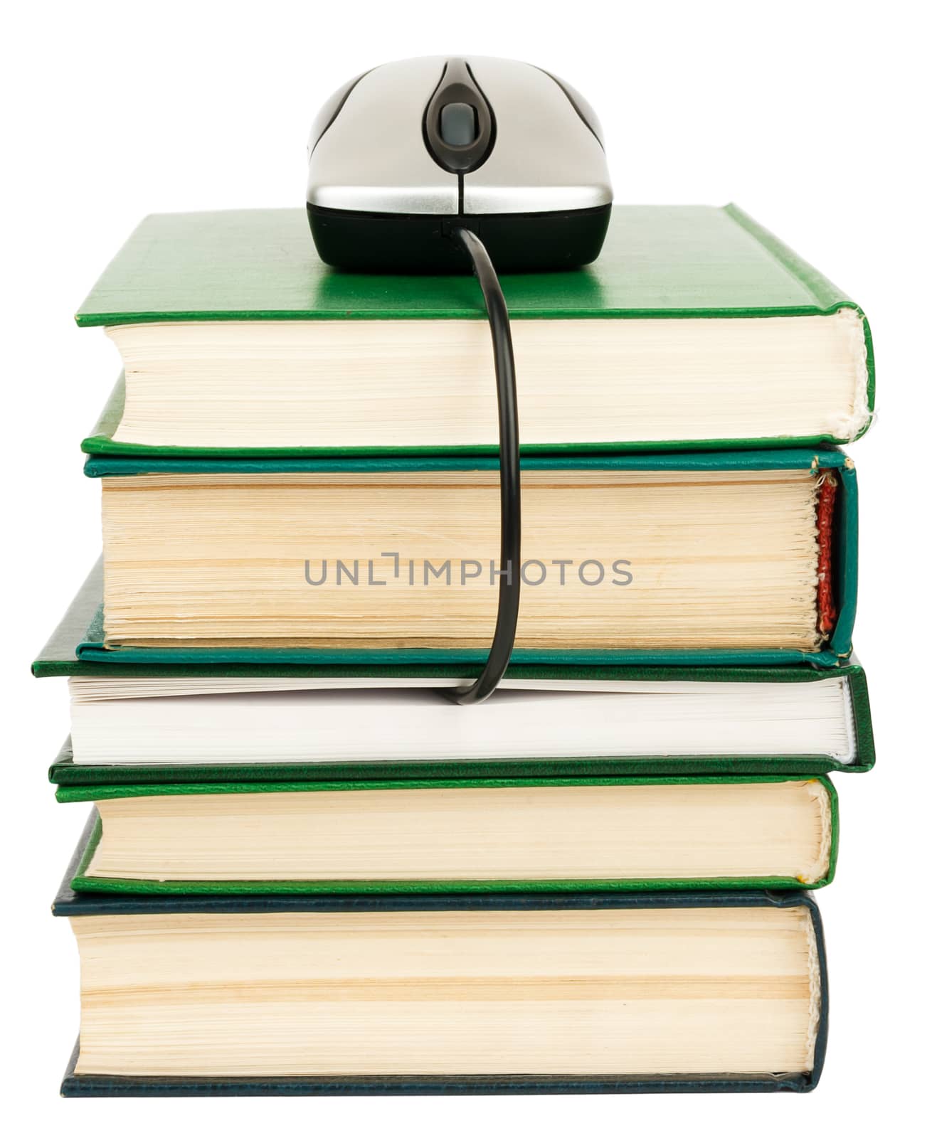 Close up of stack of books and computer mouse on white background