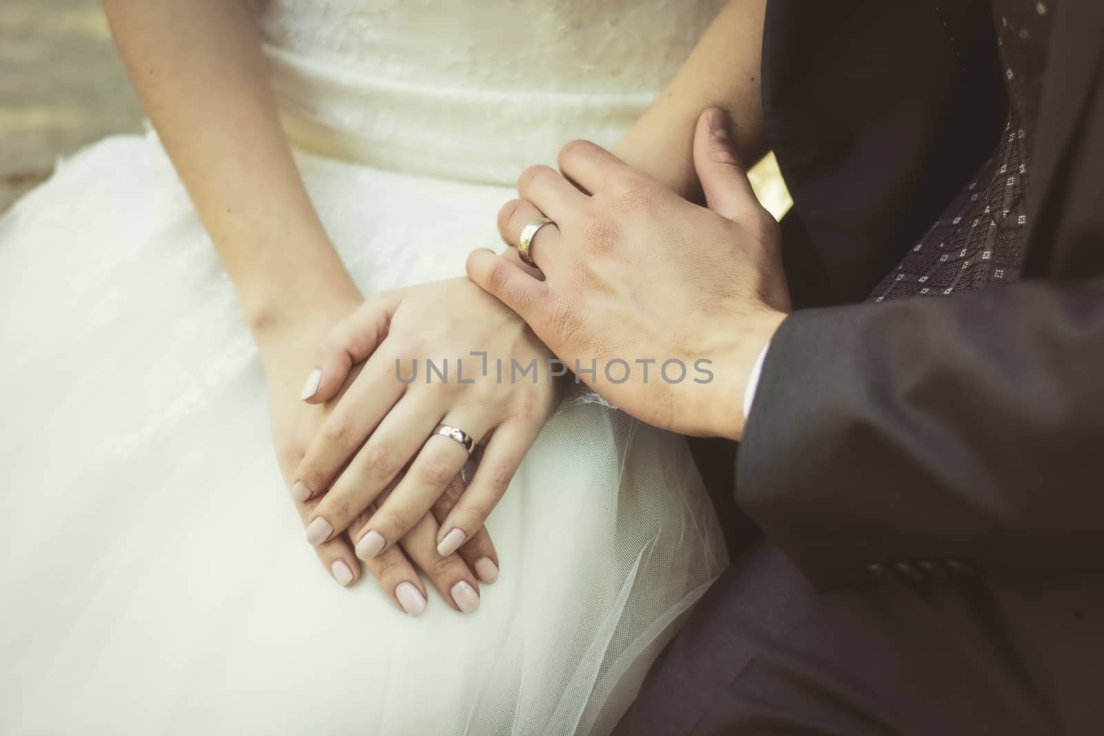 Unrecognizable couple of newly-married wearing wedding rings