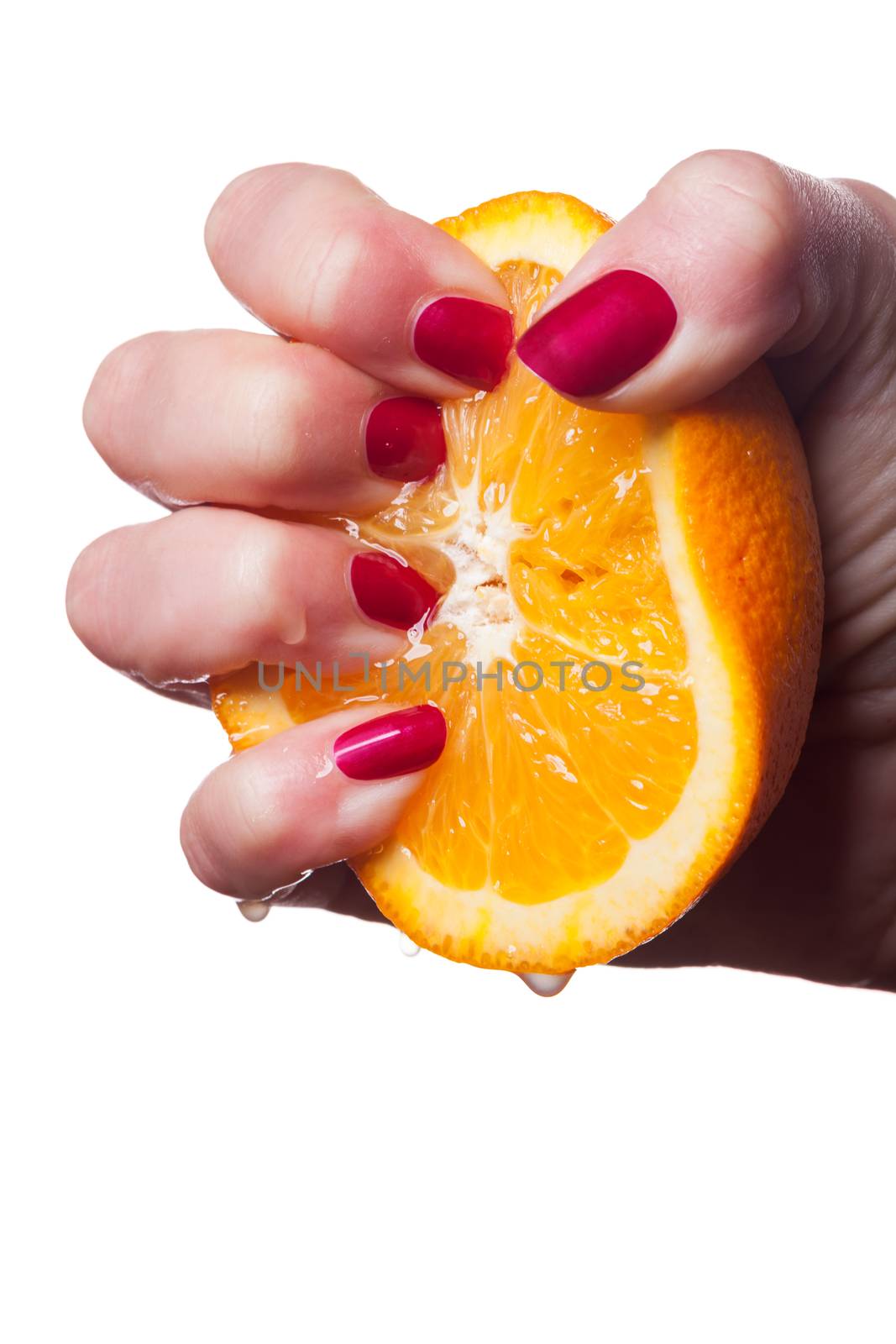 Hand with manicured nails painted a deep glossy red touch an orange on white background