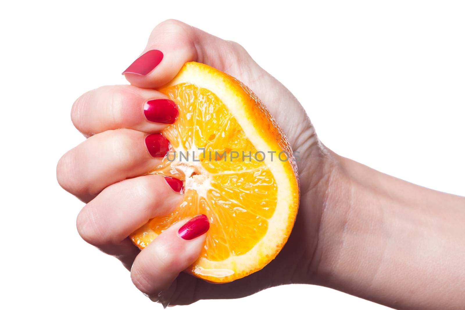 Hand with manicured nails touch an orange on white by juniart