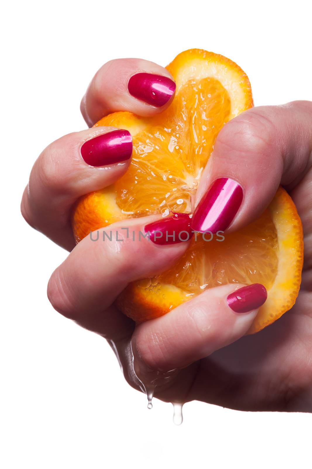 Hand with manicured nails painted a deep glossy red touch an orange on white background
