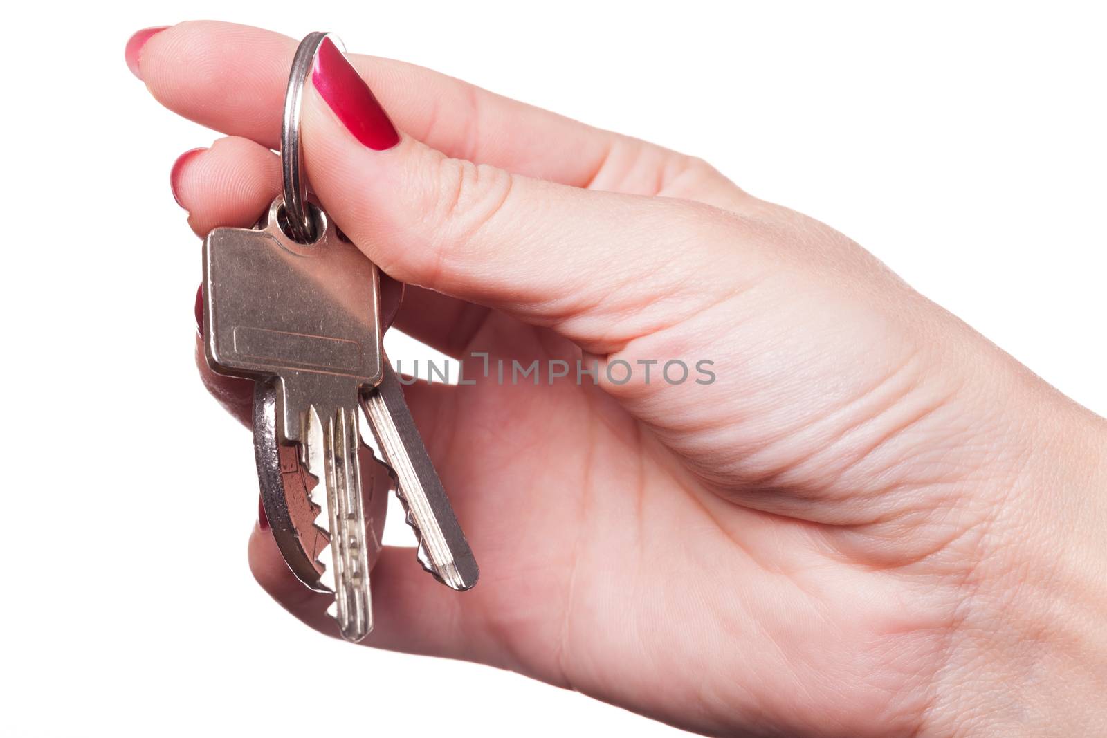 Close up of manicured fingers painted a deep glossy red curling around set of car keys