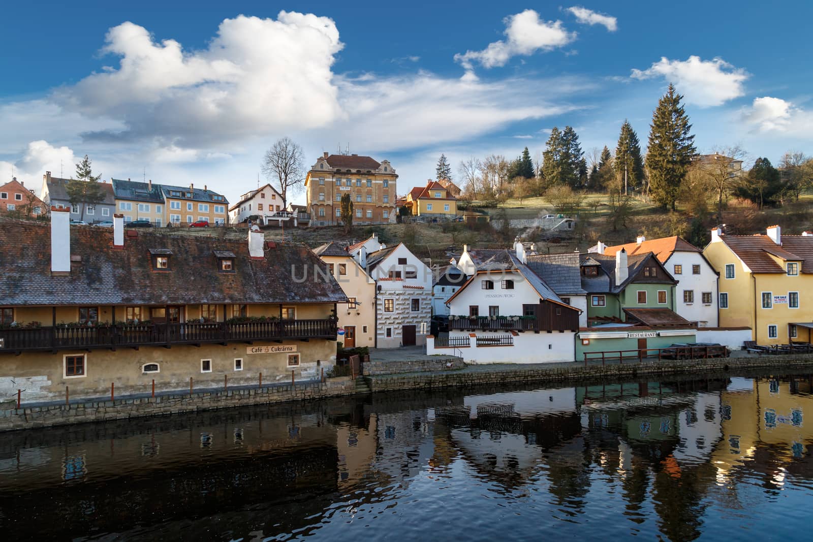 CESKY KRUMLOV, CZECH REPUBLIC - DECEMBER 29, 2015 : General view of Cesky Krumlov city with historical small houses along the river, on blue sky background.