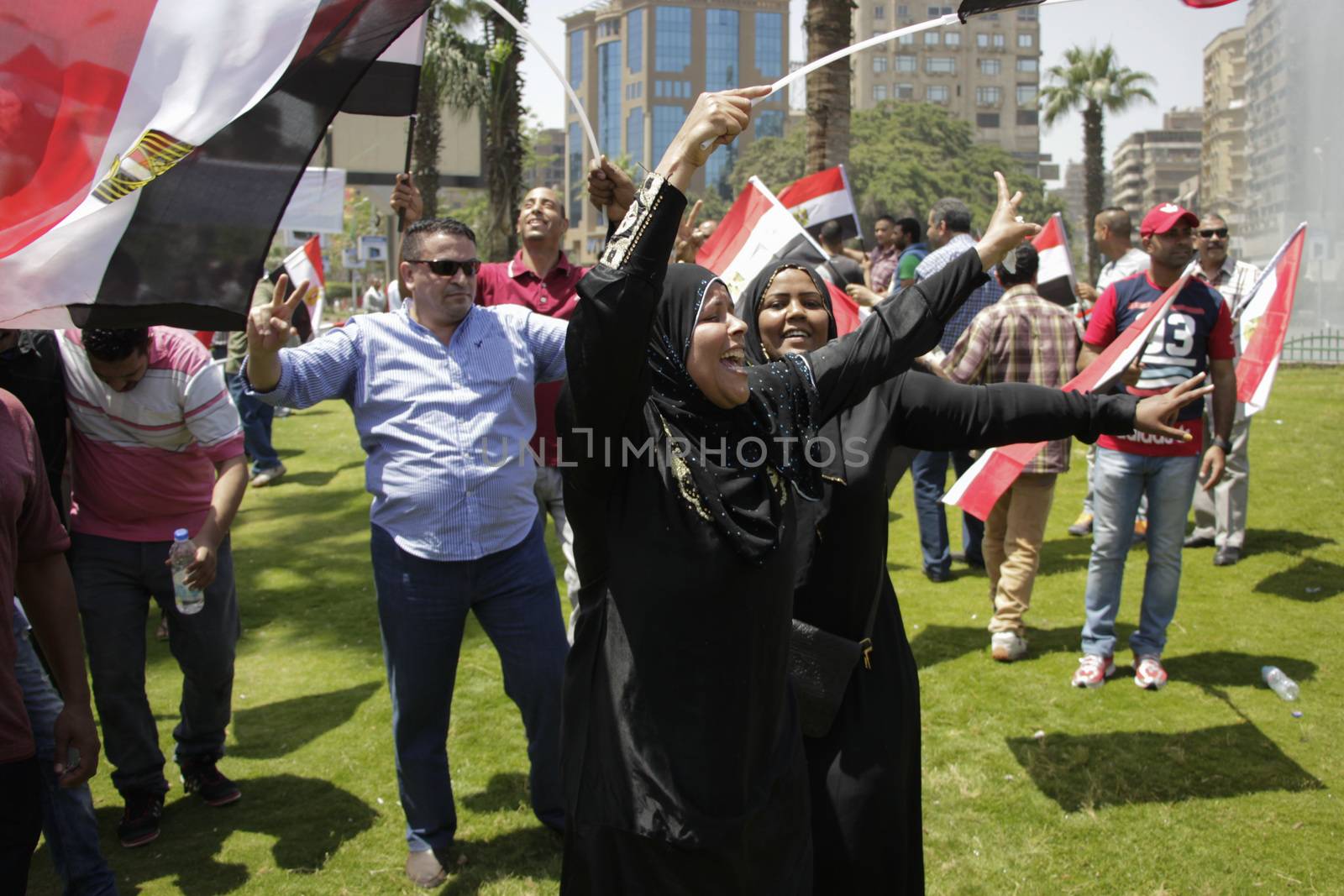 EGYPT, Giza: People wave national flags as they gather in Mostafa Mahmoud Square in Giza, near Cairo on April 25, 2016 to commemorate the thirty-fourth anniversary of Sinai liberation. This same day, thousands of security personnel were deployed around Cairo ahead of mass planned protests over the return of two Red Sea islands to Saudi Arabia, a decision that has provoked some of the most open criticism of President Abdel-Fattah el-Sissi's leadership.