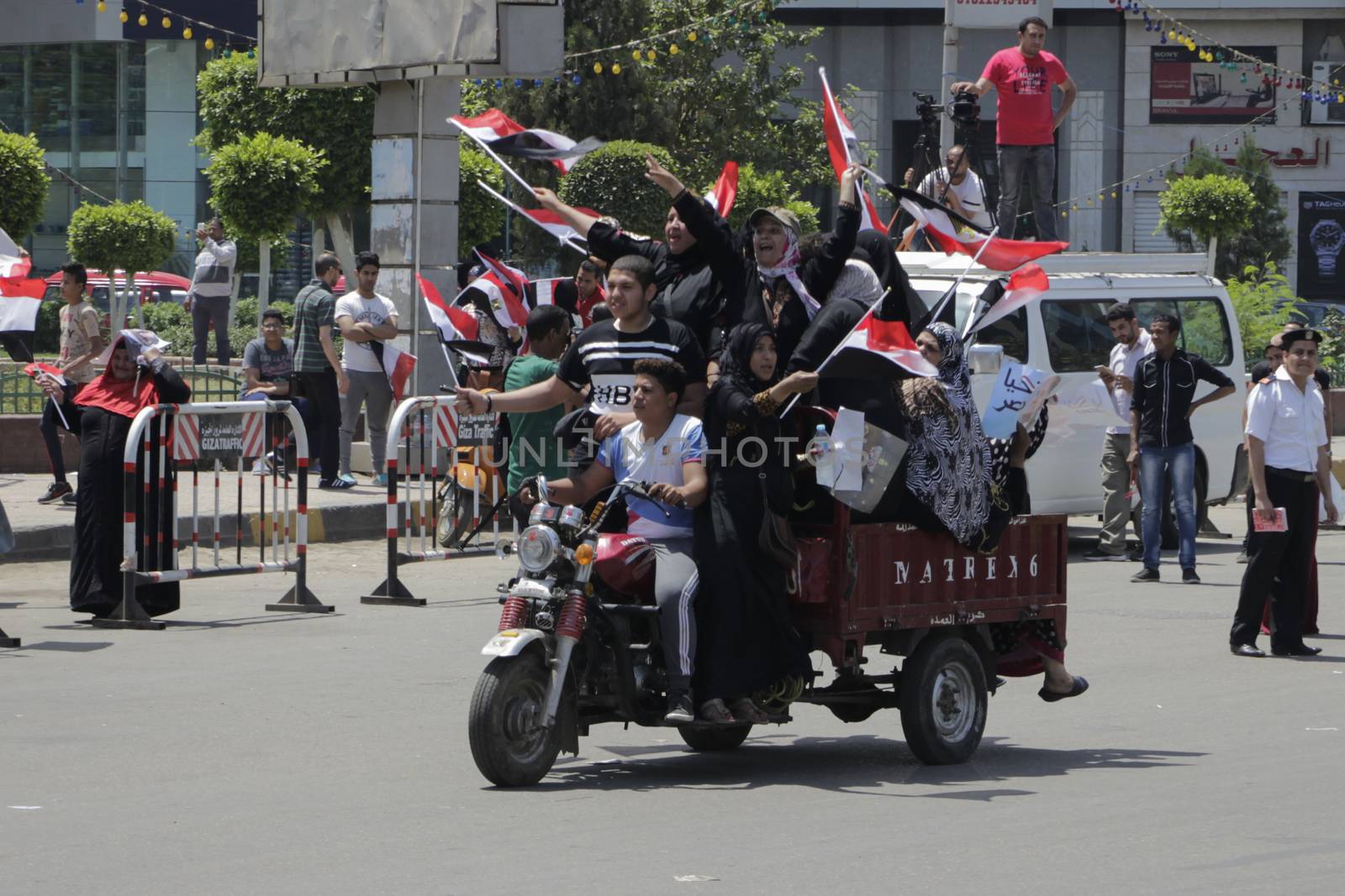 EGYPT, Giza: People wave national flags as they gather in Mostafa Mahmoud Square in Giza, near Cairo on April 25, 2016 to commemorate the thirty-fourth anniversary of Sinai liberation. This same day, thousands of security personnel were deployed around Cairo ahead of mass planned protests over the return of two Red Sea islands to Saudi Arabia, a decision that has provoked some of the most open criticism of President Abdel-Fattah el-Sissi's leadership.