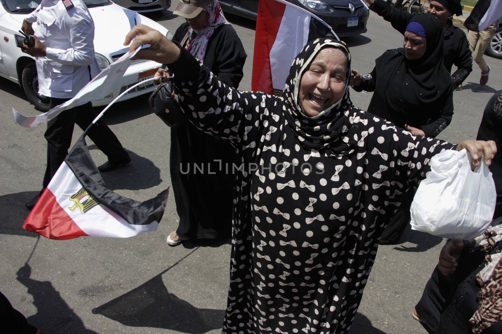 EGYPT, Giza: A woman chant as dozens gather in Mostafa Mahmoud Square in Giza, near Cairo on April 25, 2016 to commemorate the thirty-fourth anniversary of Sinai liberation. This same day, thousands of security personnel were deployed around Cairo ahead of mass planned protests over the return of two Red Sea islands to Saudi Arabia, a decision that has provoked some of the most open criticism of President Abdel-Fattah el-Sissi's leadership.