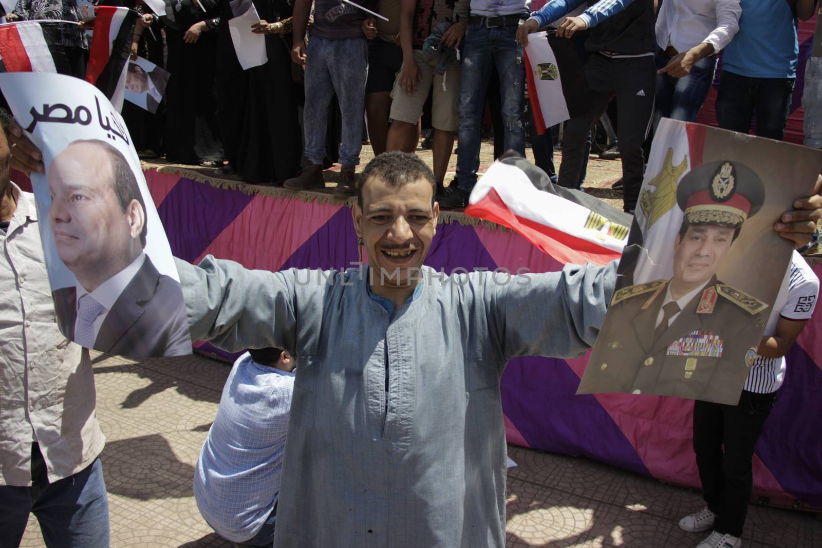 EGYPT, Giza: A man holds portraits of Egyptian president Abdel-Fattah el-Sissi reading Long live Egypt as dozens gather in Mostafa Mahmoud Square in Giza, near Cairo on April 25, 2016 to commemorate the thirty-fourth anniversary of Sinai liberation. This same day, thousands of security personnel were deployed around Cairo ahead of mass planned protests over the return of two Red Sea islands to Saudi Arabia, a decision that has provoked some of the most open criticism of President Abdel-Fattah el-Sissi's leadership.