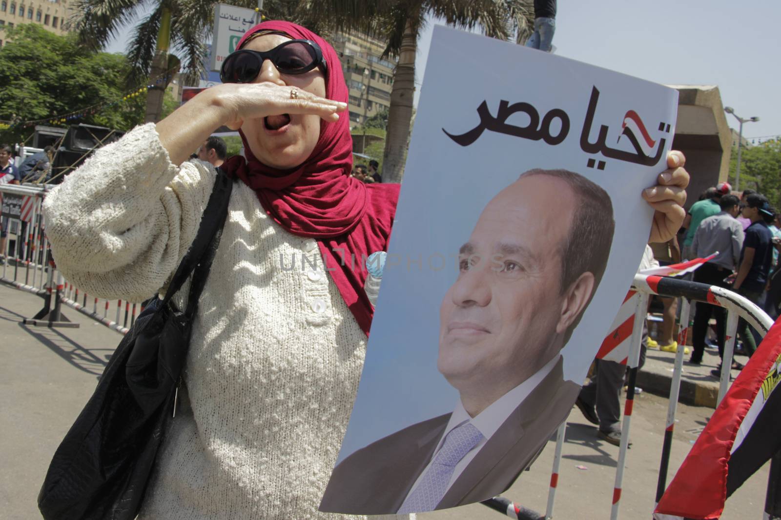 EGYPT, Giza: A woman holds a portrait of Egyptian president Abdel-Fattah el-Sissi reading Long live Egypt and gather in Mostafa Mahmoud Square in Giza, near Cairo on April 25, 2016 to commemorate the thirty-fourth anniversary of Sinai liberation. This same day, thousands of security personnel were deployed around Cairo ahead of mass planned protests over the return of two Red Sea islands to Saudi Arabia, a decision that has provoked some of the most open criticism of President Abdel-Fattah el-Sissi's leadership.