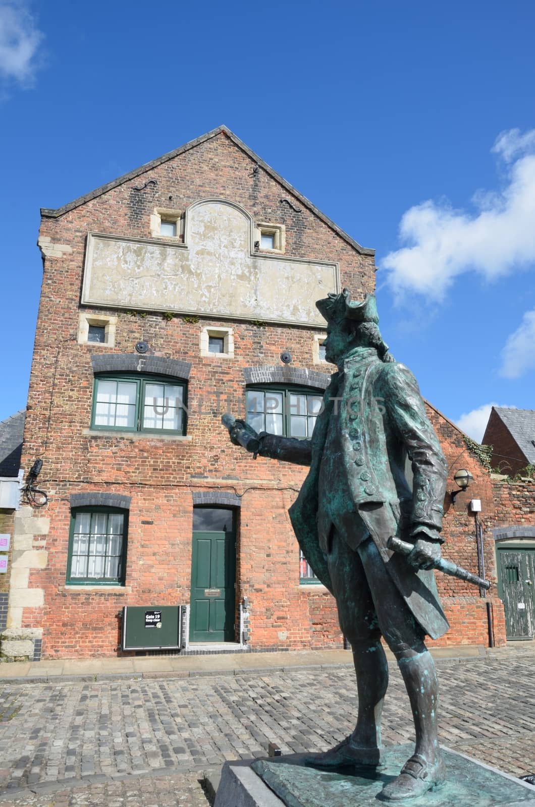 Statue of Maritime figure in front of Warehouse