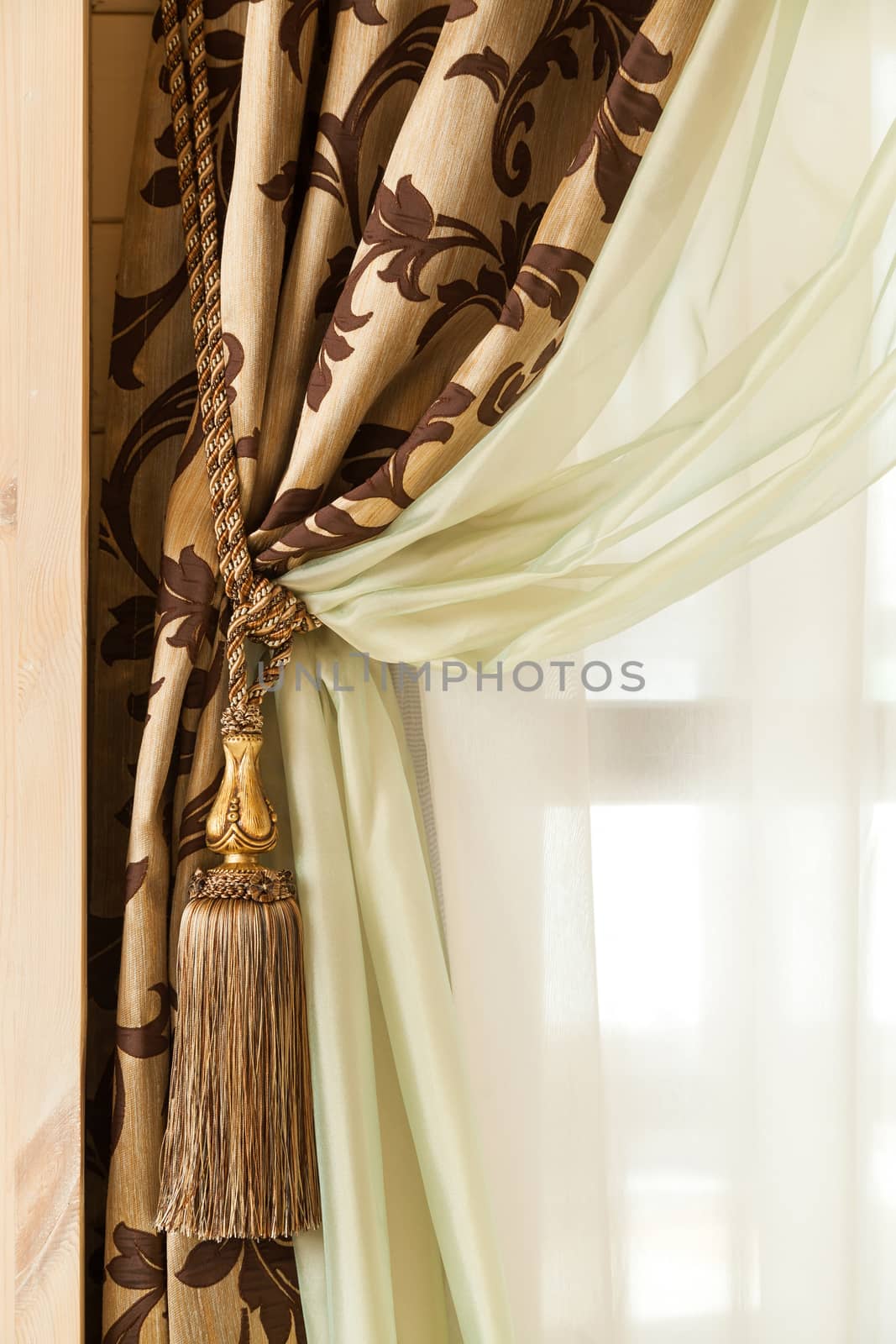 richly decorated curtain with a holding strap by sveter