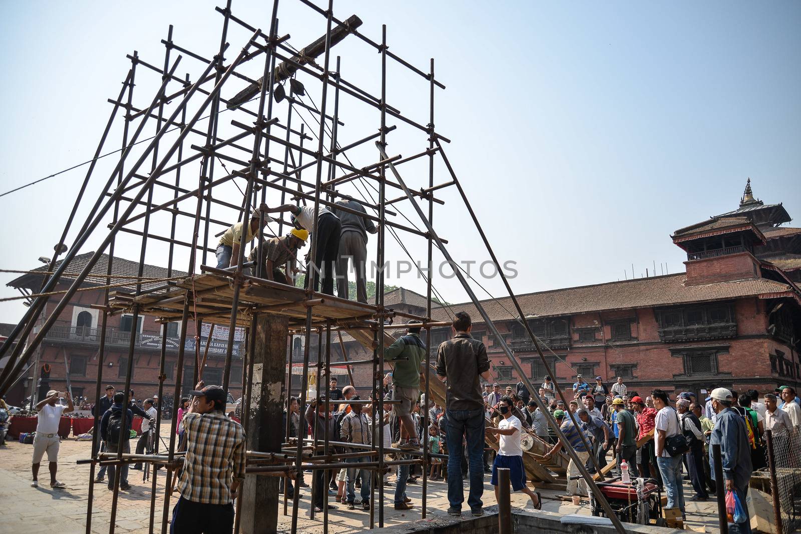 NEPAL, Kathmandu: Men begin rebuilding heritage sites damaged by the earthquake a year ago, on April 25, 2016, at Patan Durbar Square in Kathmandu, in Nepal, during the first anniversary of the quake.Some 9,000 people were killed in the 7.8-magnitude quake that struck April 25, 2015 and its aftershocks. . 