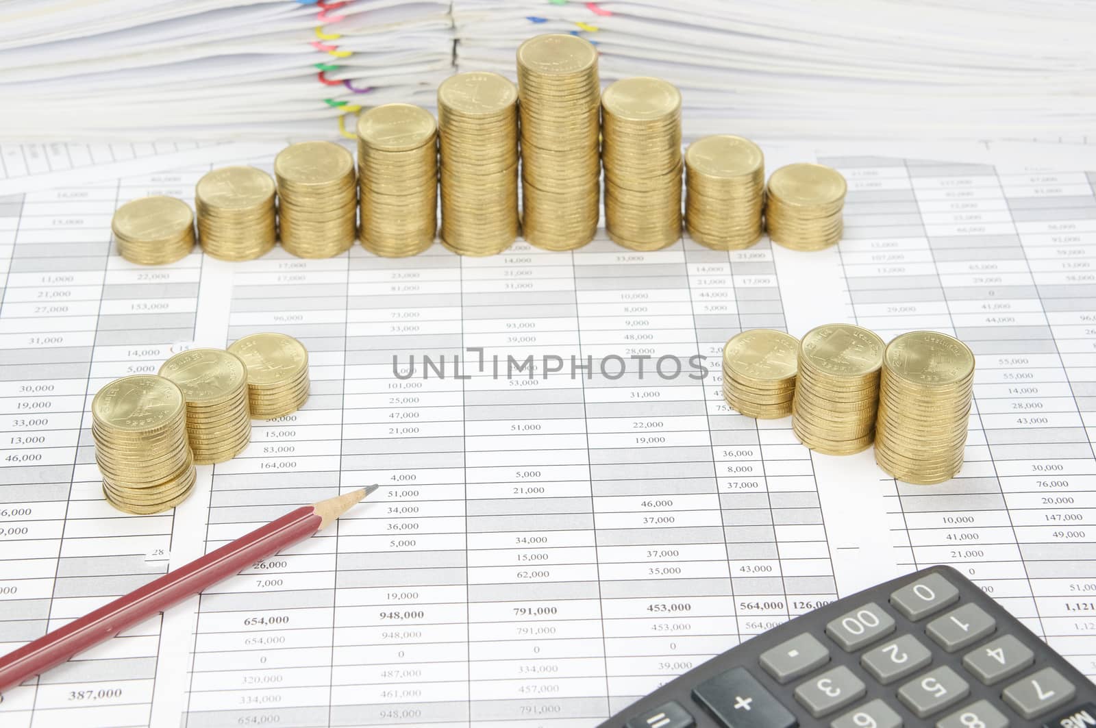 Brown pencil have step pile of gold coins as background by eaglesky