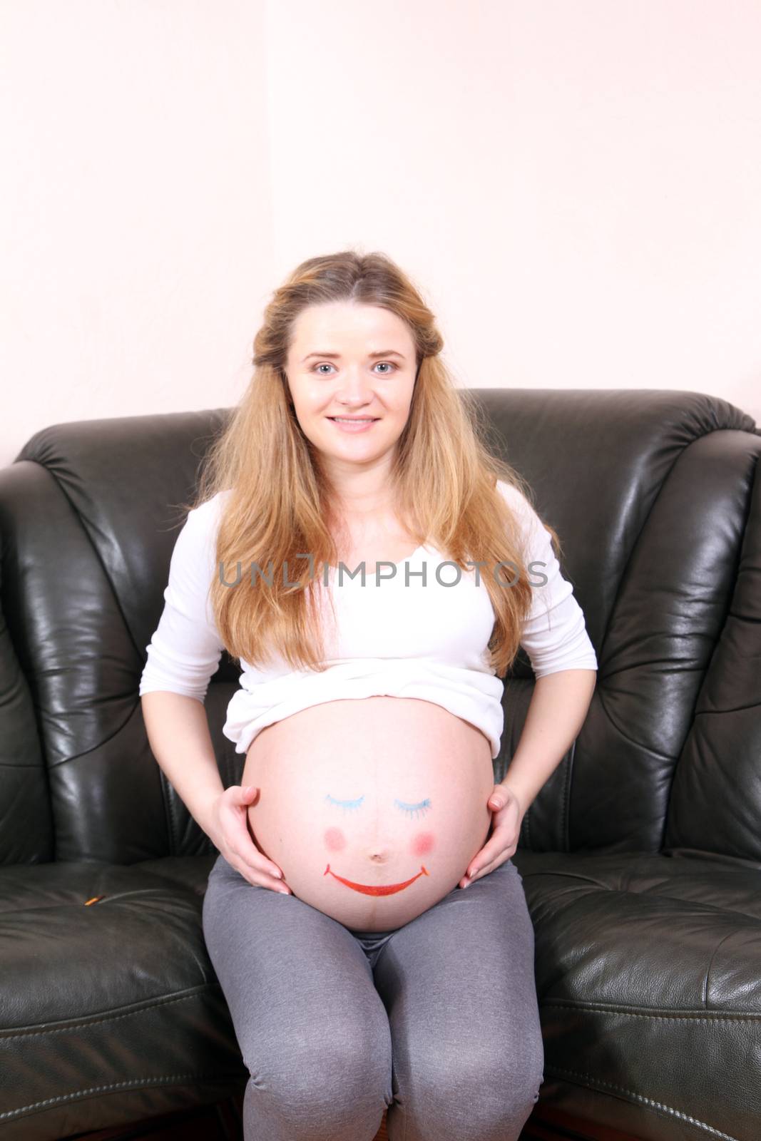 Pregnant woman with a painted face on a stomach sleeper by Irina1977