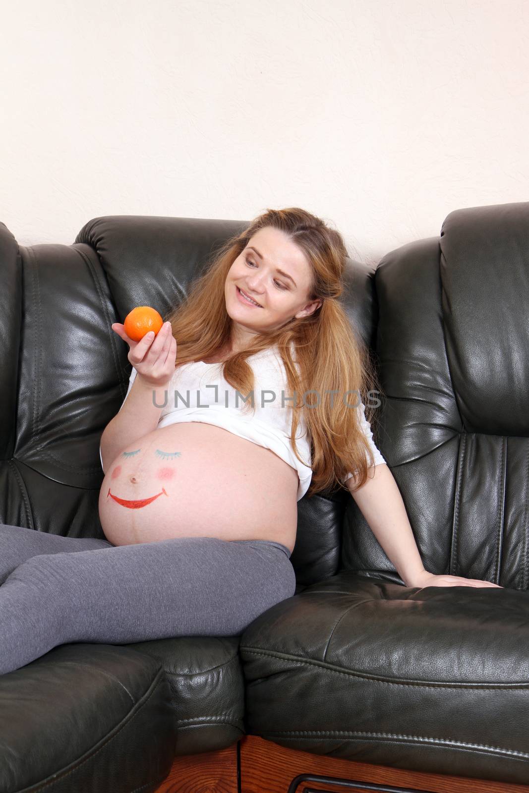 Pregnant woman with a painted face on a stomach sleeper by Irina1977