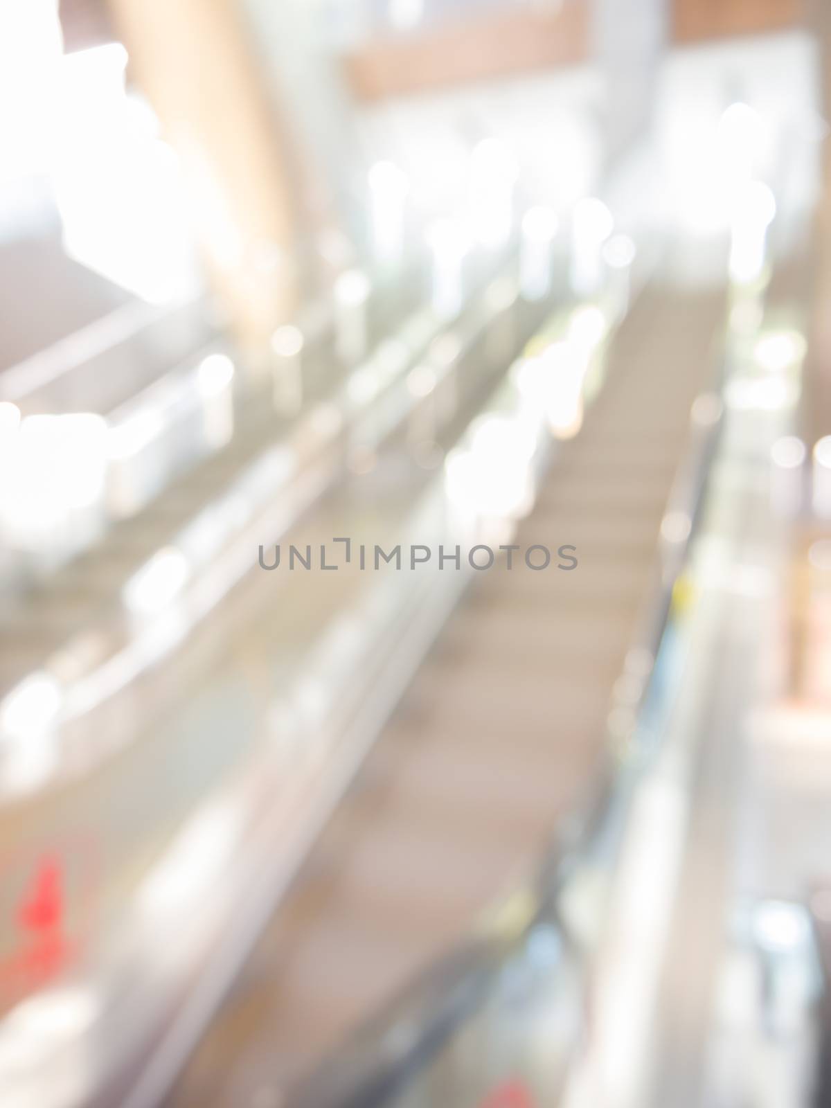 blurred escalator in shopping mall as background