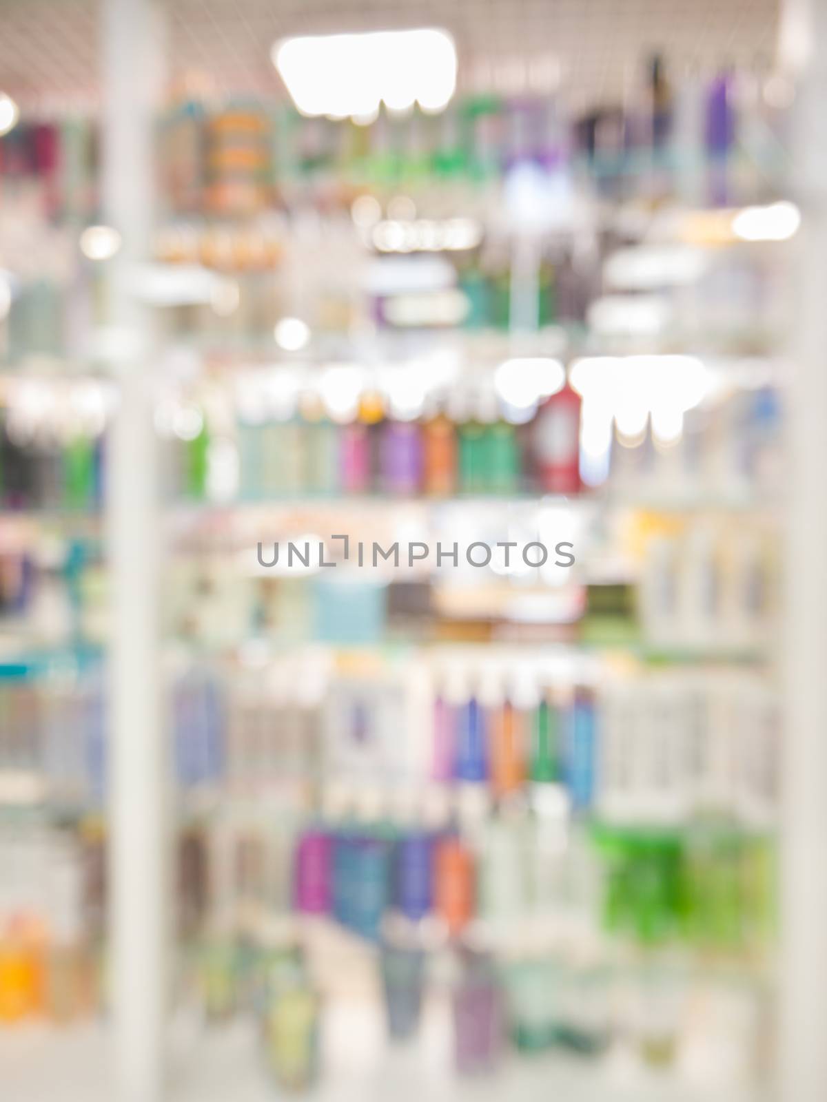 Blurred colorful supermarket products on shelves - Shampoo bottles background