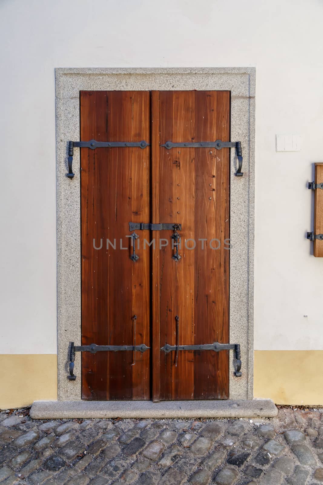 Close up detailed view of old wooden door on a white wall.