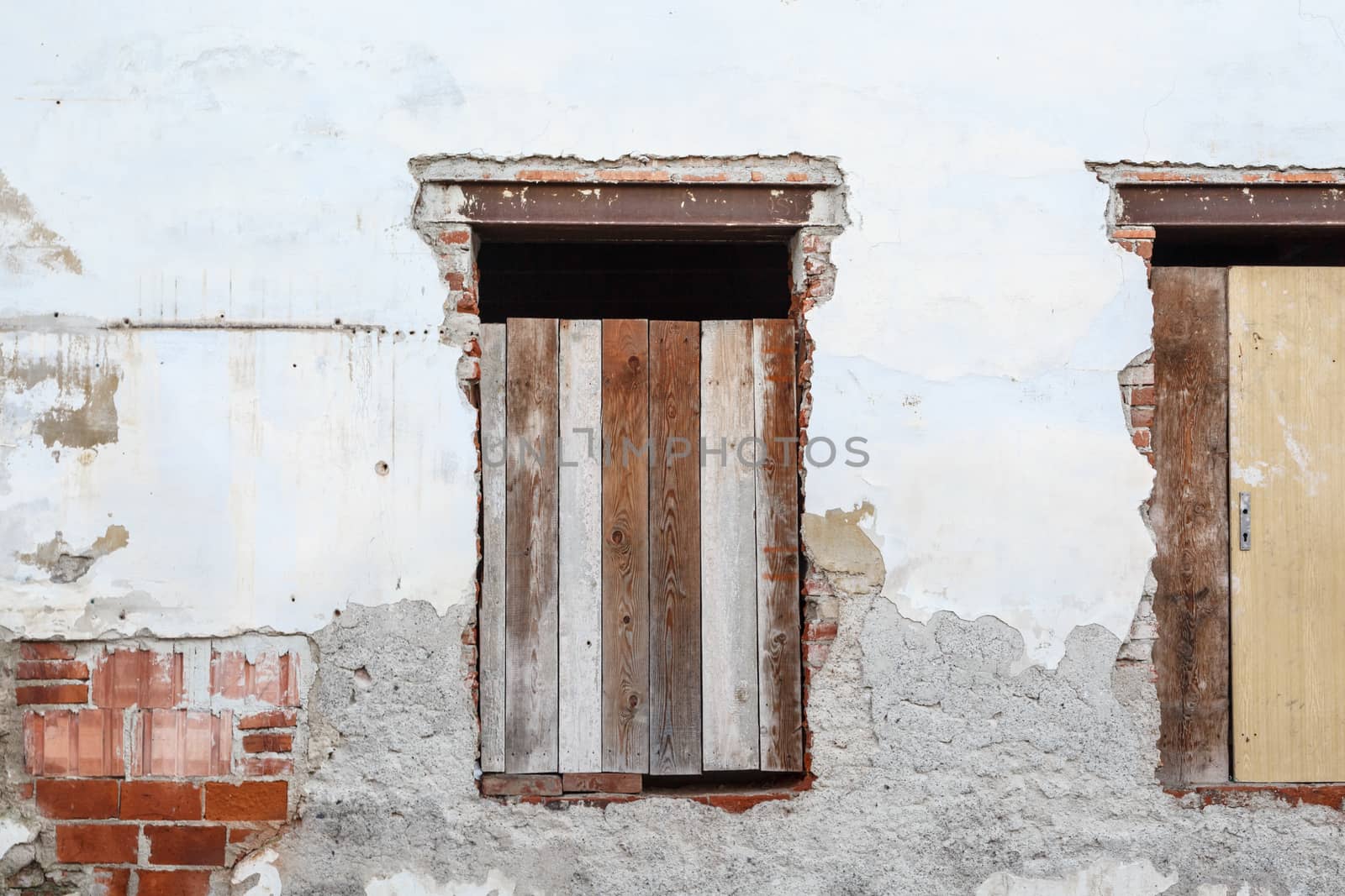 Close up detailed view of old wooden door on a white wall.