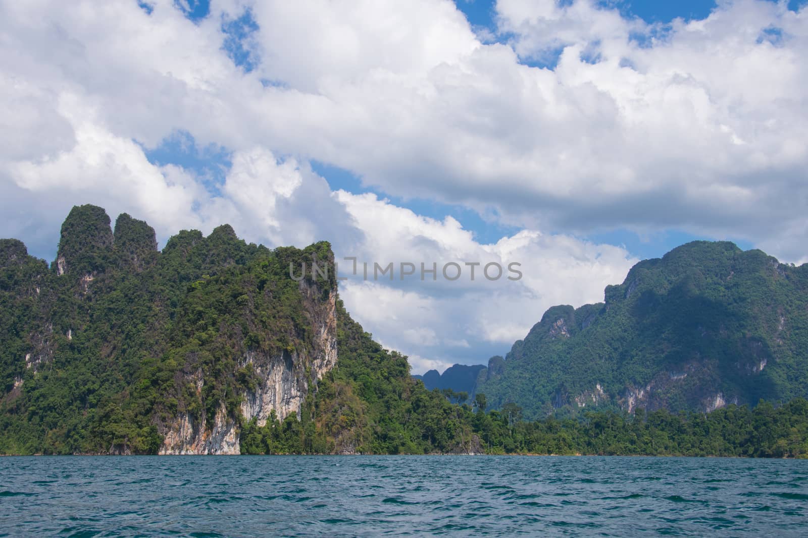 Beautiful mountains behind fog in Ratchaprapha Dam at Khao Sok National Park, Surat Thani Province, Thailand